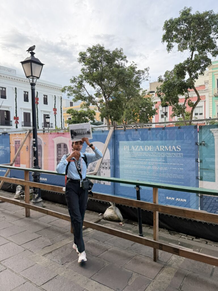Walking tour guide explaining the history of Old San Juan while holding an old photograph