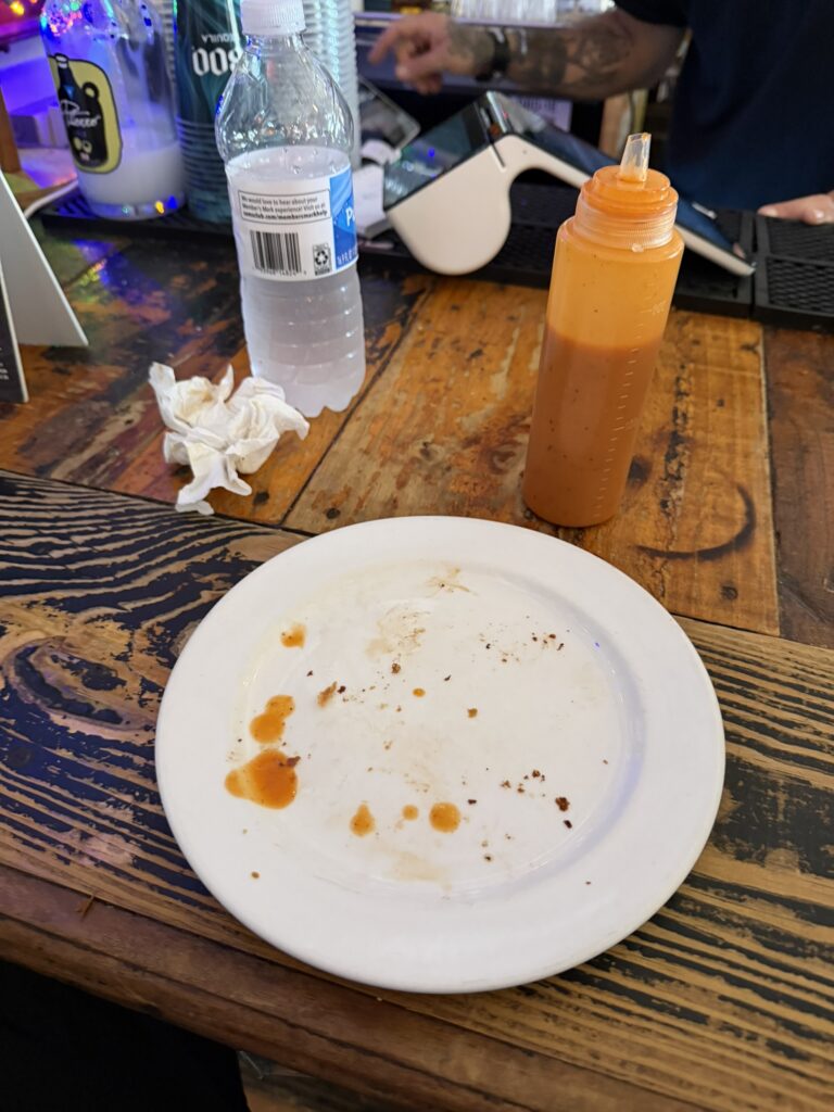 Pastrami empanadas and hot sauce served at the bar at Deshistoria properly shlayed