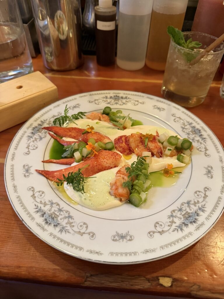 Lobster à la Parisienne with vegetables and sauce at Au Pied de Cochon